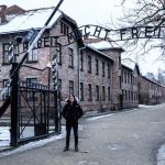 David Simpson at the gate in Auschwitz, Oświęcim, Poland. Full guide & itinerary for Krakow