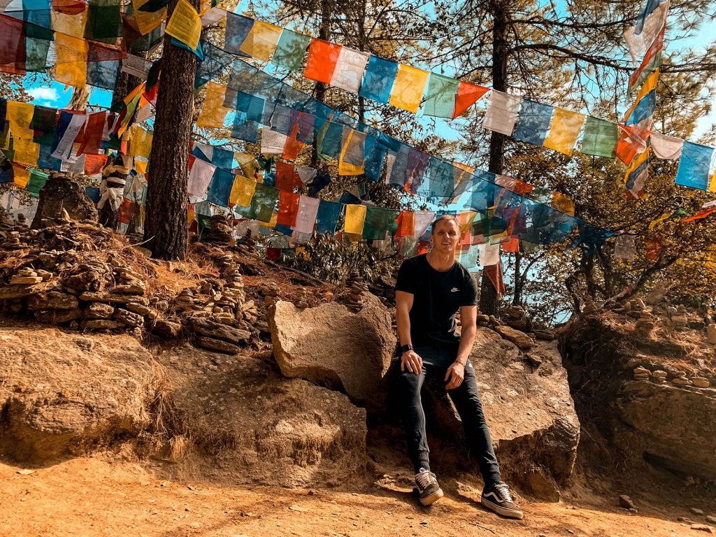David Simpson resting on a rock in Bhutan. The Tiger's Nest, Bhutan & Thailand