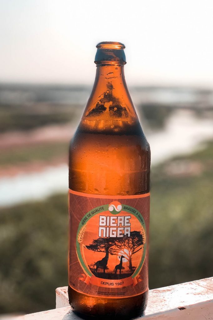 Bottle of beer in Niger. Flying a drone in Niger