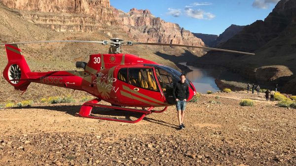 David Simpson and helicopter in Grand Canyon, USA. Helicopter tour over the Grand Canyon