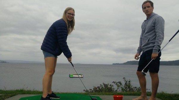 David Simpson and a girl playing golf at Lake Taupo in NZ. Eating eggs and playing golf in Lake Taupo