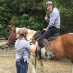 David Simpson riding a horse in NZ. White water rafting and games at River valley