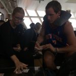 David Simpson onboard the ferryboat playing cards with a friend girl in Abel Tasman, New Zealand. Wellington & Abel Tasman