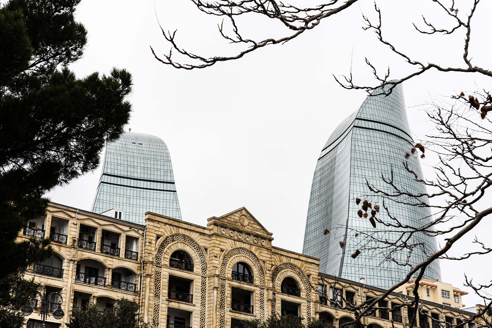 The Flame Towers and old architecture in Baku, Azerbaijan. Confused taxis and pick ups
