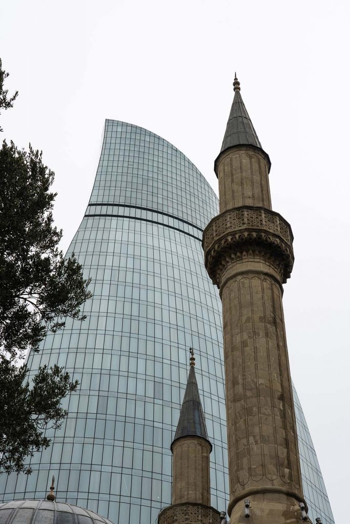 Flame Towers and minarets in Baku, Azerbaijan. Confused taxis and pick ups