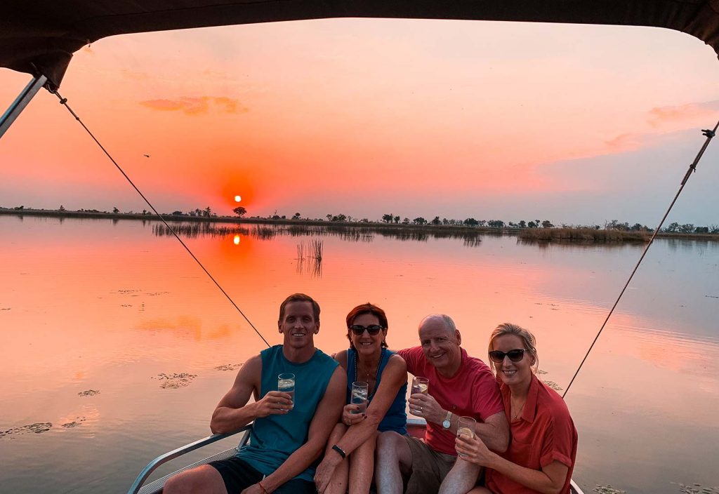 David Simpson and family at sunset in Okavango Delta in Botswana, Africa. An owl and African sunsets
