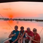 David Simpson and family at sunset in Okavango Delta in Botswana, Africa. An owl and African sunsets