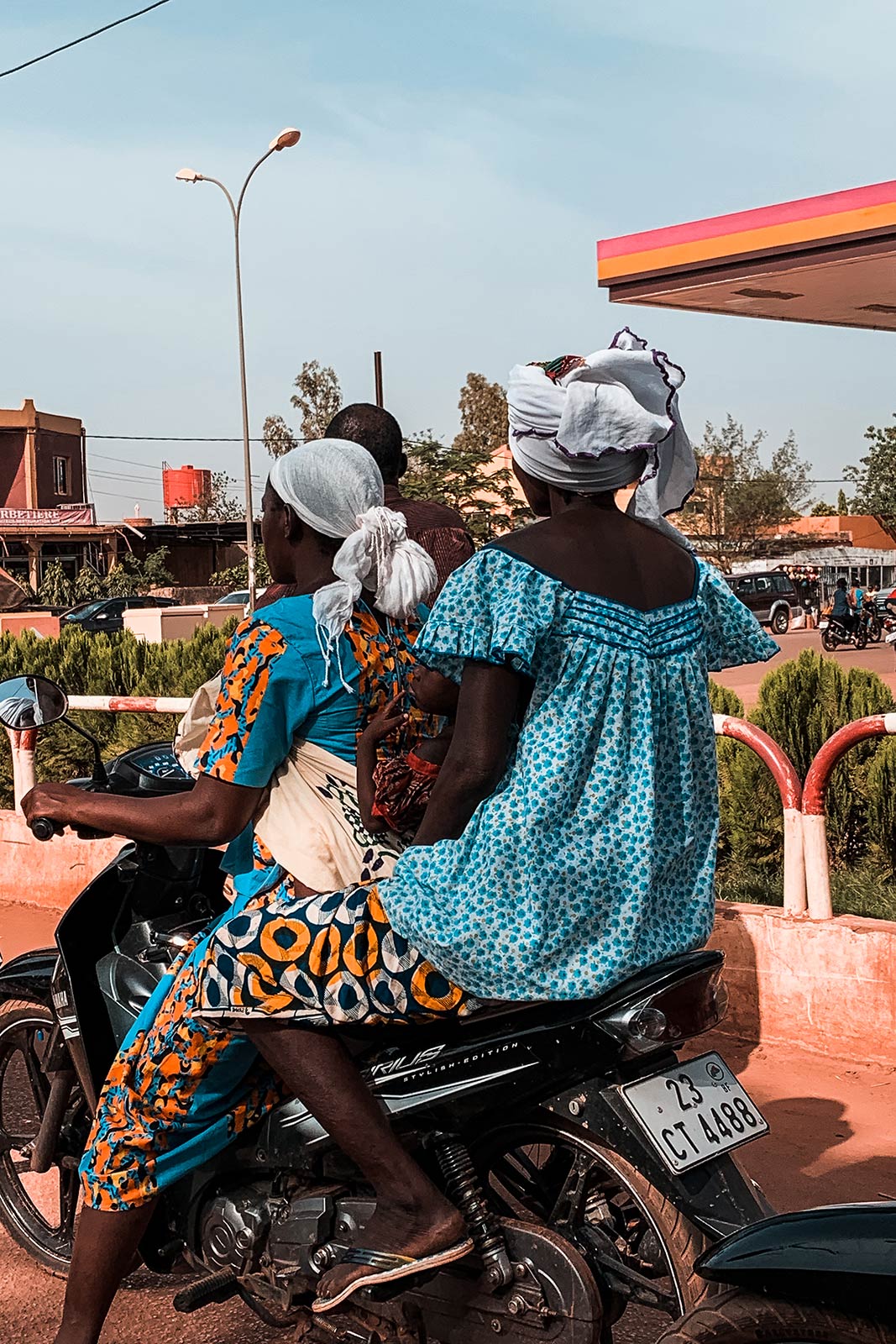 Locals riding motorcycle in Ouagadougou, Burkina Faso. The heat of Ouaga