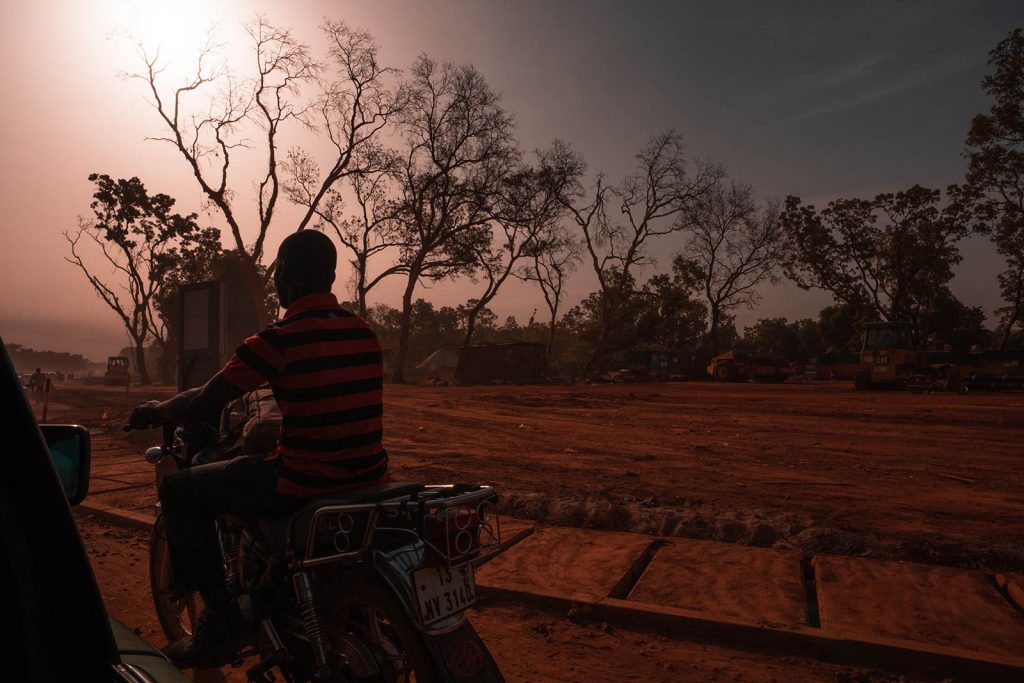 Local riding motorcycle in Ouagadougou, Burkina Faso. The most horrible zoo