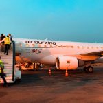 Airplane at airport in Niger. Negotiating with taxi drivers in Niger