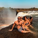 David Simpson and family with a local guy at Devil's Pool at Victoria Falls in Zambia, Africa. The devil's pool
