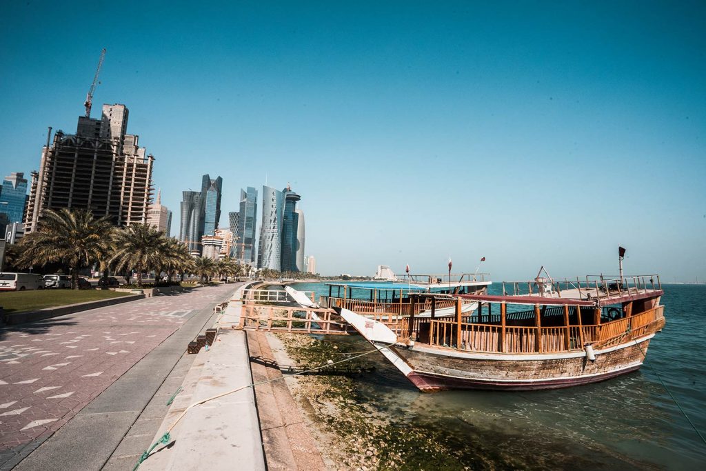 Traditional dhow wooden boats at Corniche Marina in Doha, Qatar. Swimming in Doha Airport