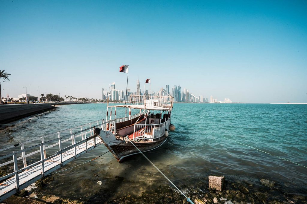 Traditional dhow wooden boat at Corniche Marina in Doha, Qatar. Swimming in Doha Airport