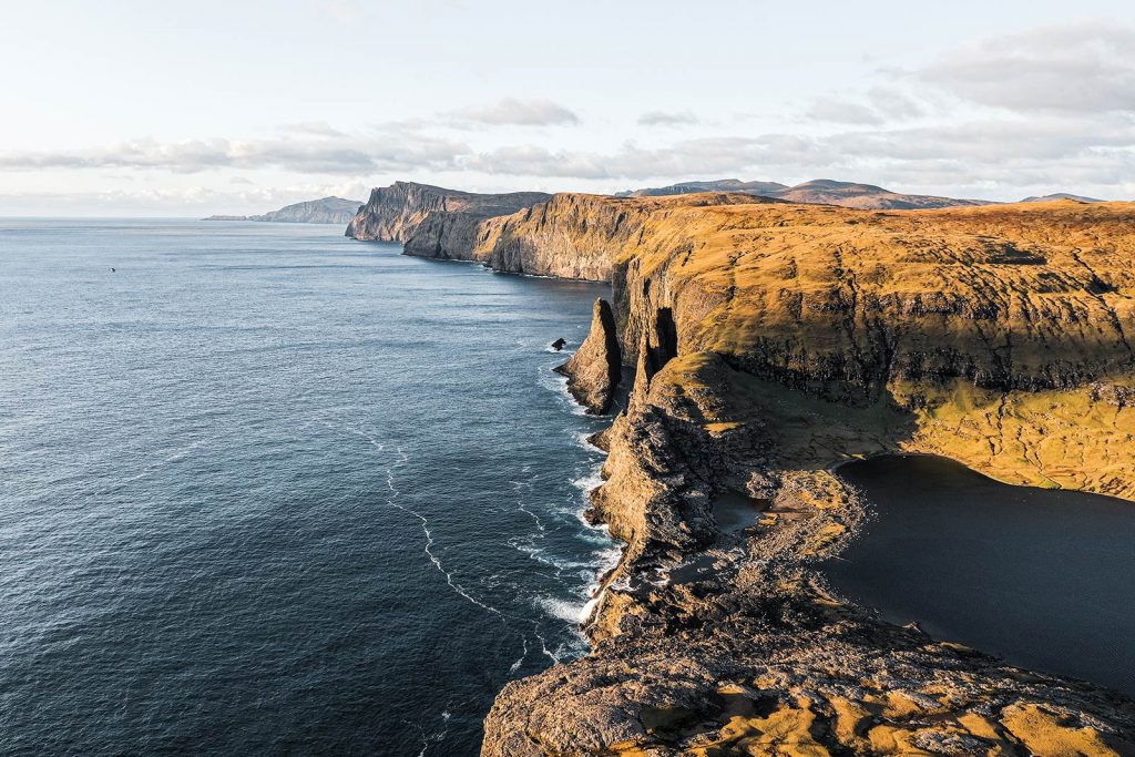 Trælanípa Slave Cliff and Leitisvatn Lake in Faroe Islands. The Faroe Islands has me