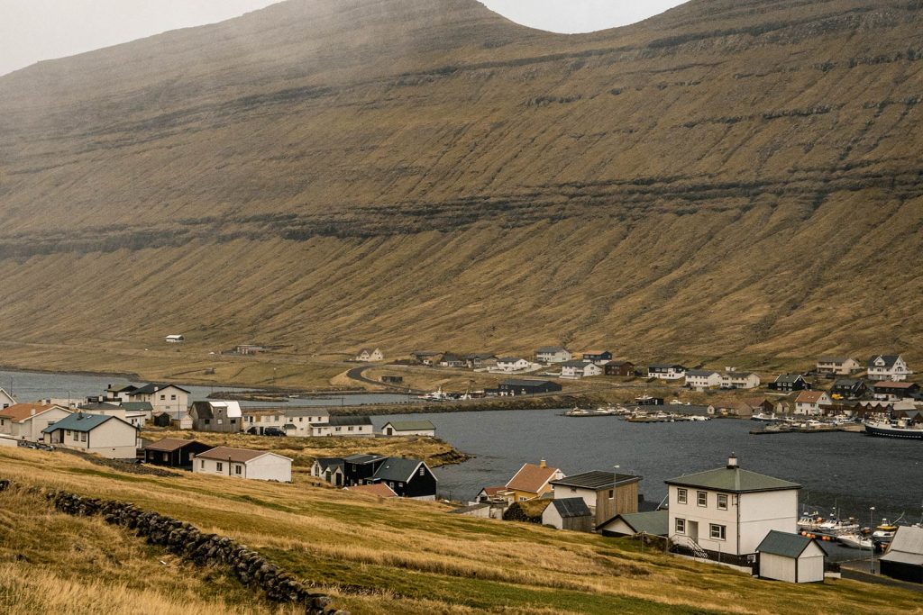 Houses at Vidoy in Faroe Islands. Getting blown off Mt Villingardalsfjall