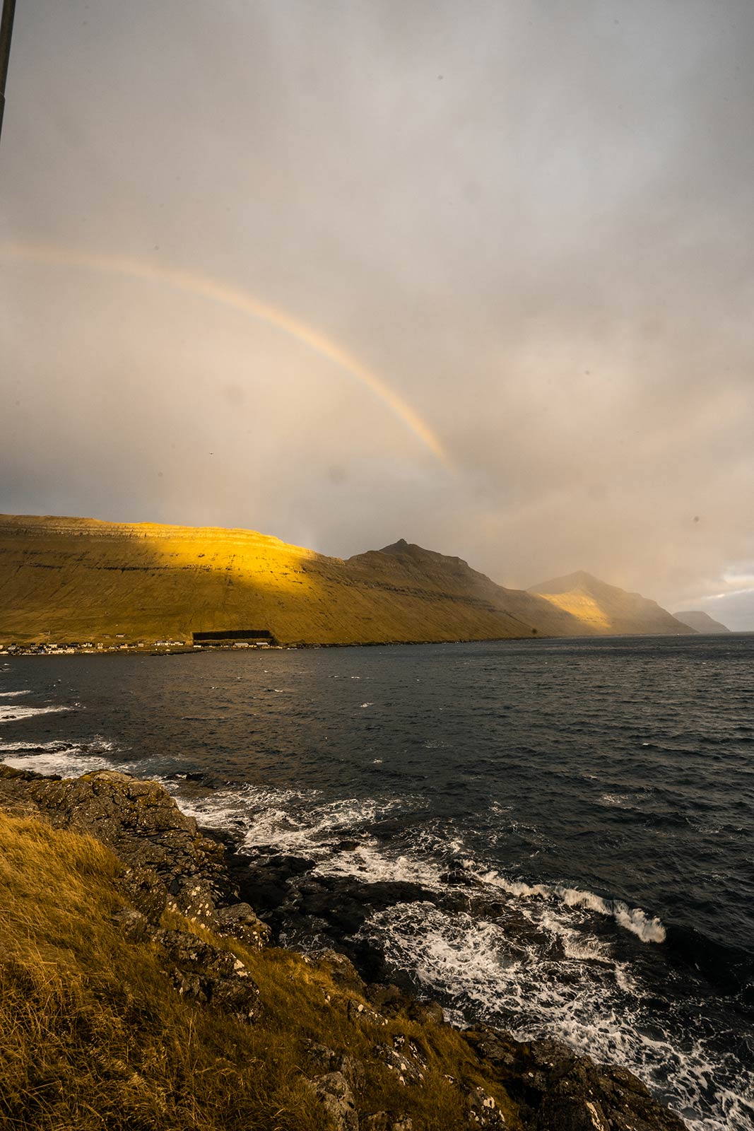 Rainbow at Villingdalsfjall in Faroe Islands. Getting blown off Mt Villingardalsfjall
