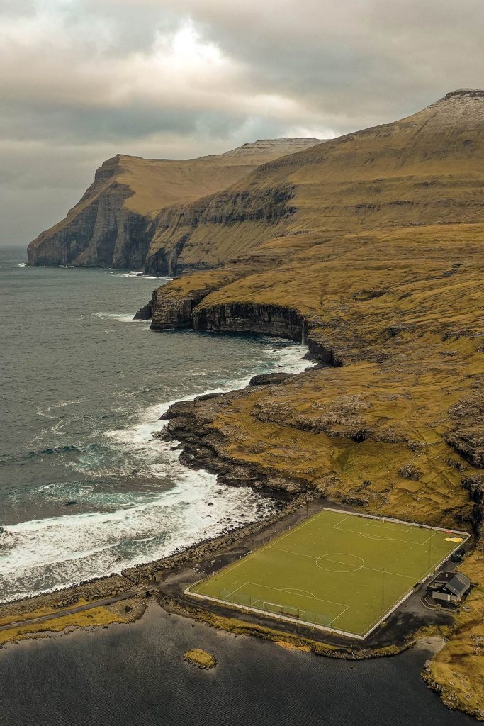 Football field at Gjogv in Faroe Islands. The Nordic series, reflection post