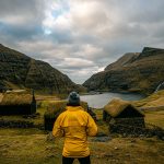 David Simpson and houses with turf roof at Saksun in Faroe Islands. The gem of the Faroe Islands