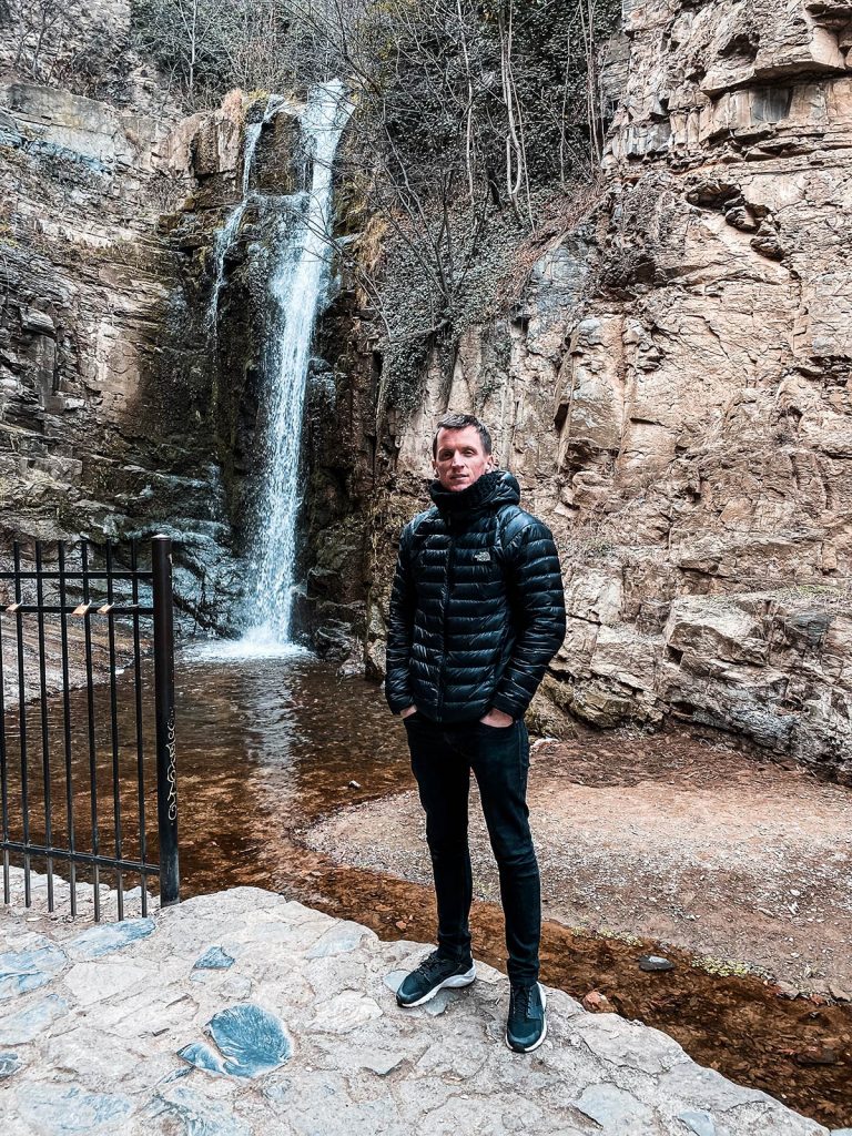 David Simpson at waterfall in Tbilisi, Georgia. My tour guide getting his dates wrong... by 12 months