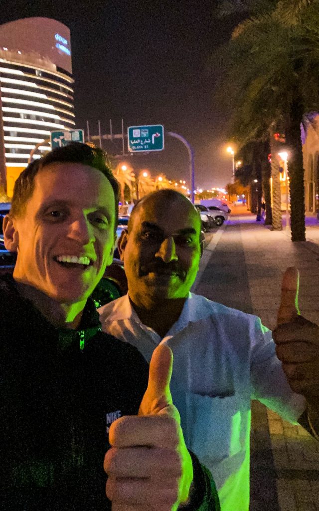 David Simpson with taxi driver at night in Saudi Arabia. Arriving into Saudi Arabia