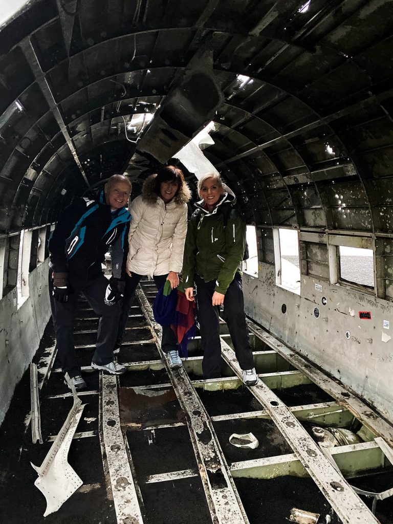 Family at Sólheimasandur Plane Wreck in Iceland. From one paradise to another