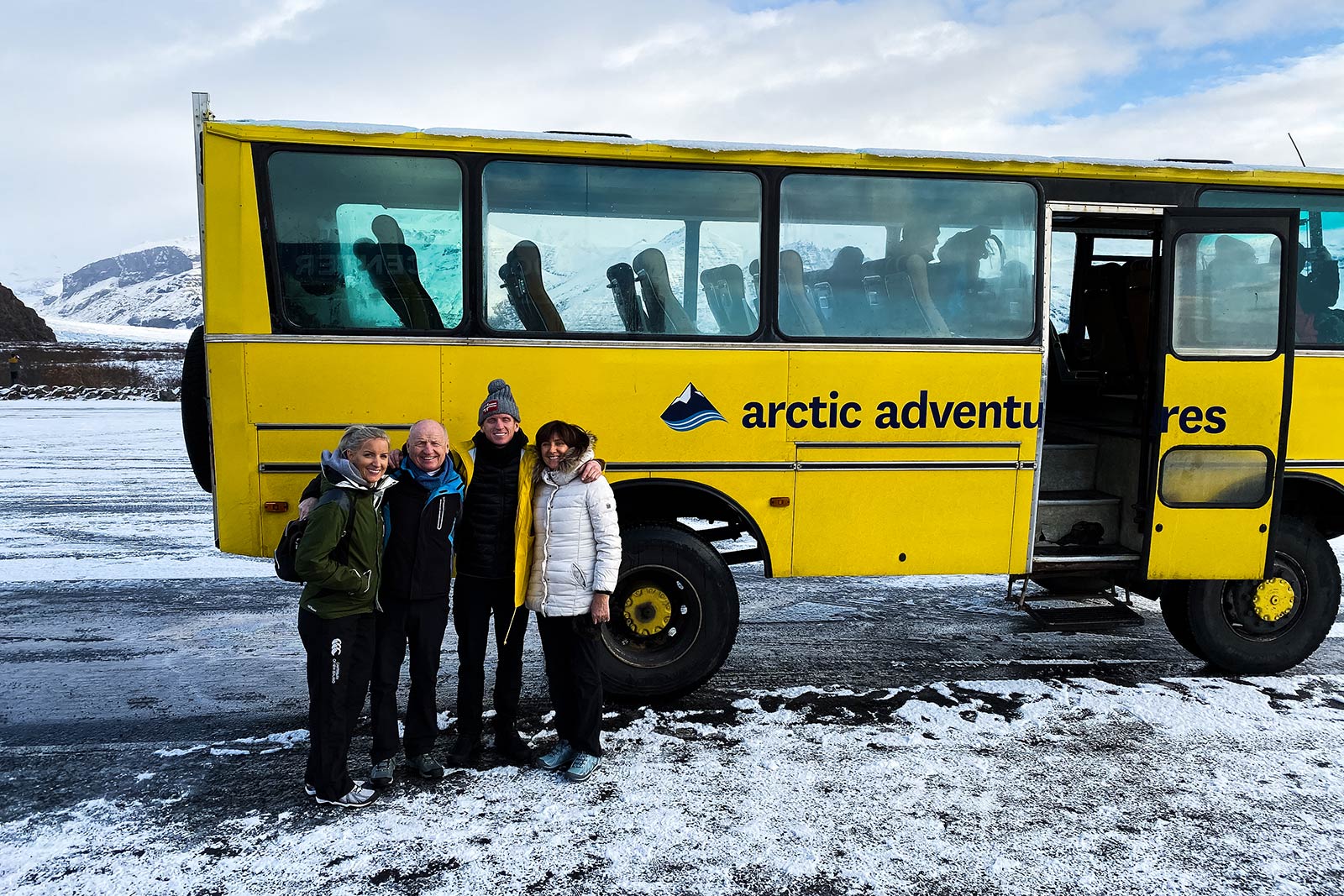 David Simpson and family by the tour bus at Skaftafellsjokul glacier in Iceland. Ice caving in Iceland