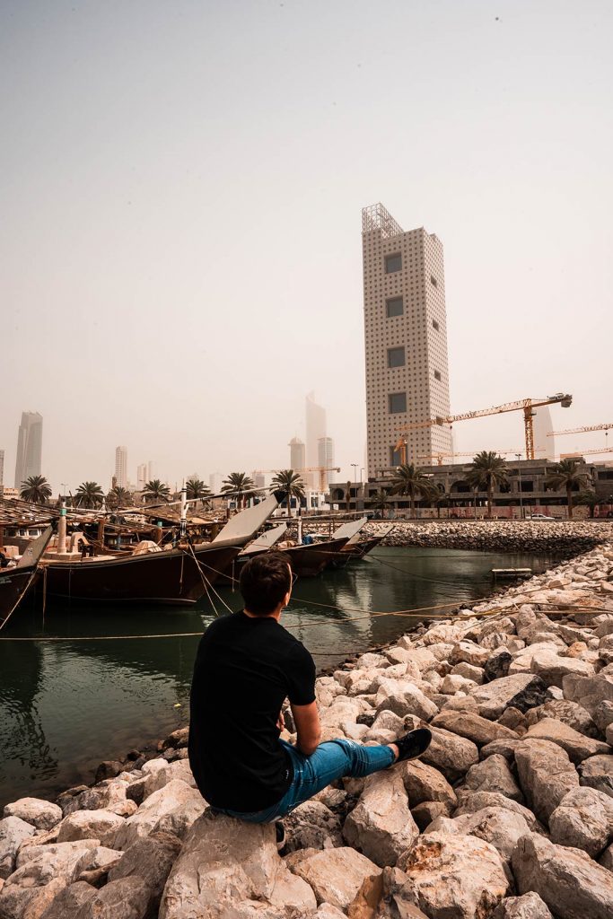 David Simpson sitting by the pier looking at buildings in Kuwait. The most insane waterfight in the world