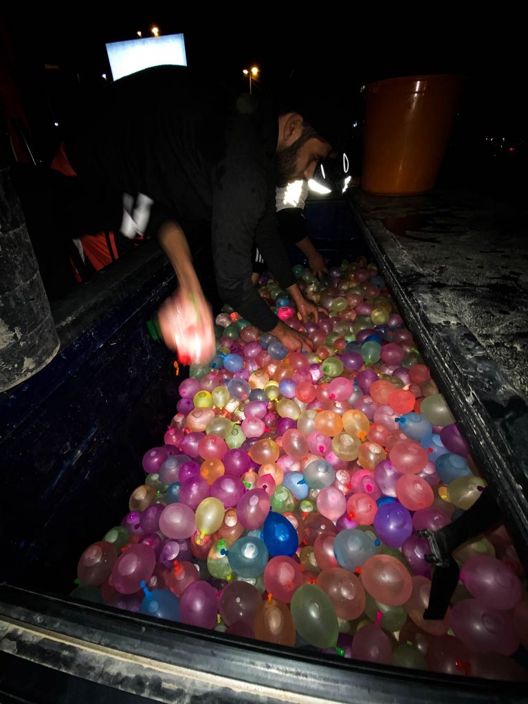 Local guy preparing his water balloons in Kuwait. The oil series, reflection post