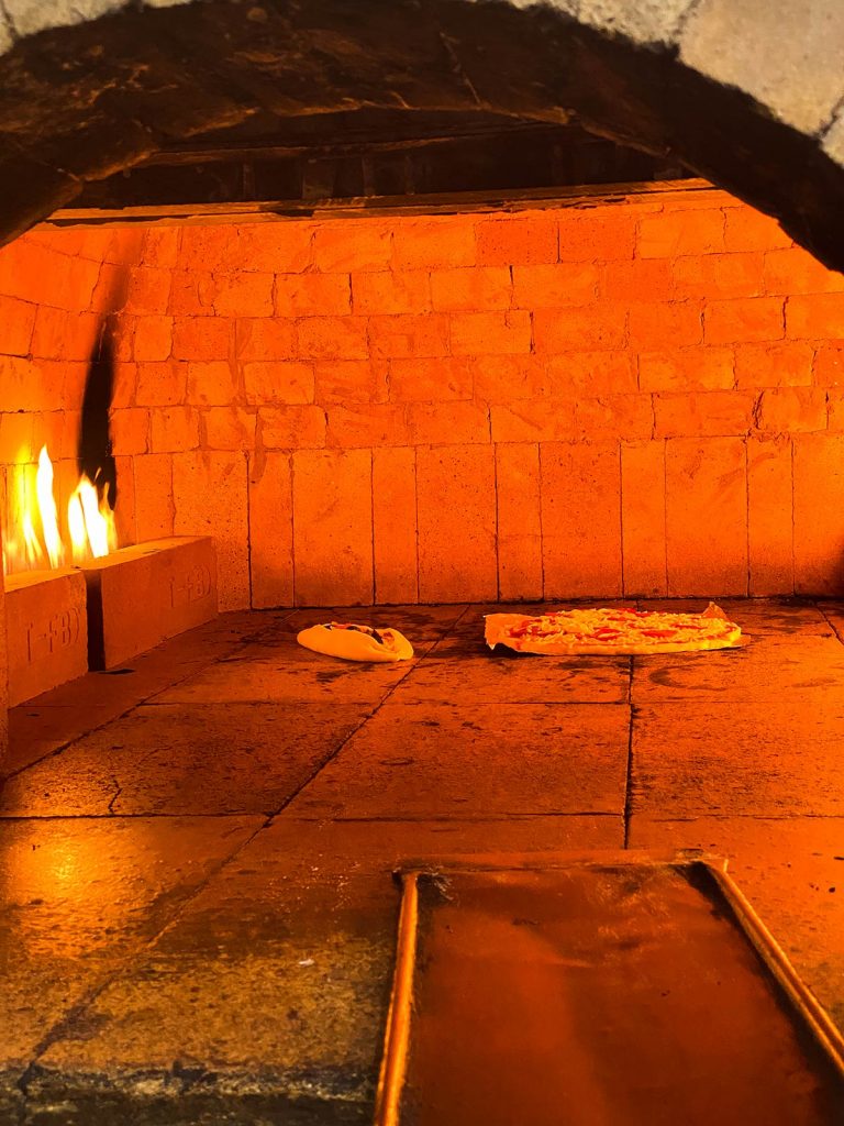Pizza cooking inside oven at Ovenji Pizza Shop in Kuwait. The most insane waterfight in the world