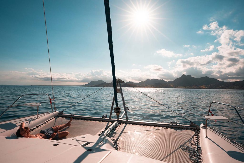 David Simpson sunning onboard catamaran in Mauritius, Africa. Sailing around Maritius