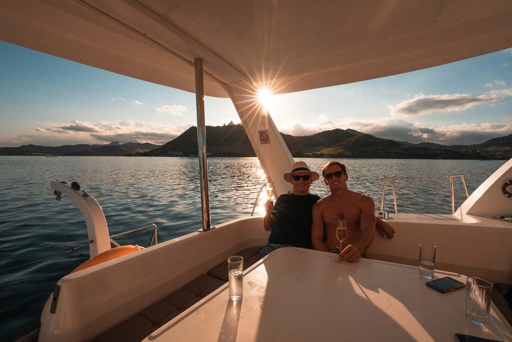 David Simpson and dad onboard catamaran in Mauritius, Africa. Sailing around Maritius