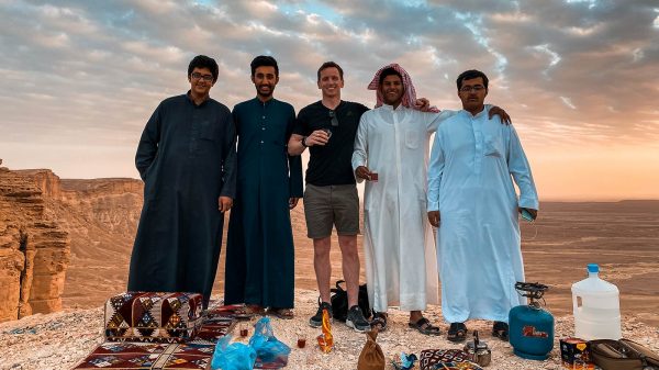 David Simpson drinking tea with locals at amphitheater in Saudi Arabia. A trip to the edge of the world