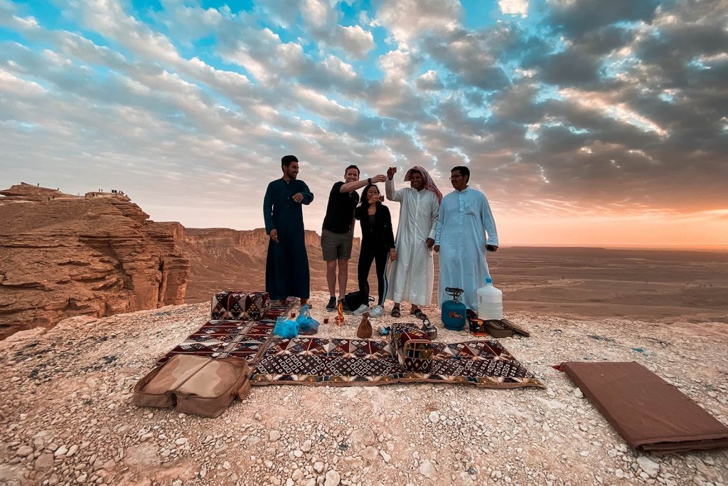 David Simpson with friends at amphitheater during sunset in Saudi Arabia. A trip to the edge of the world