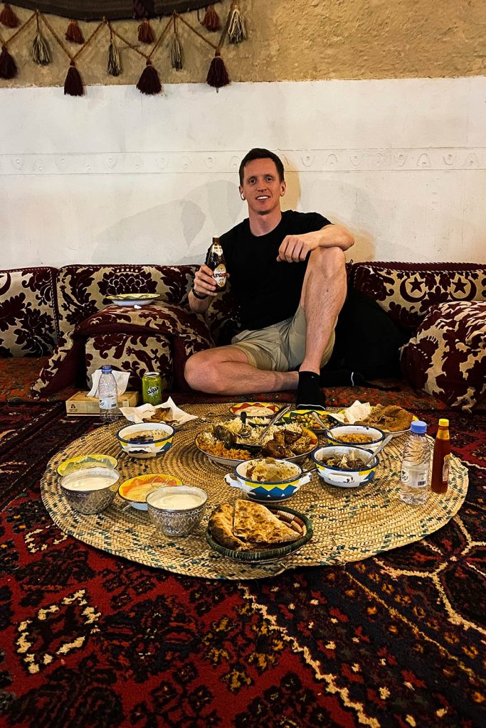 David Simpson eating food at Najd Village in Riyadh, Saudi Arabia. The oil series, reflection post