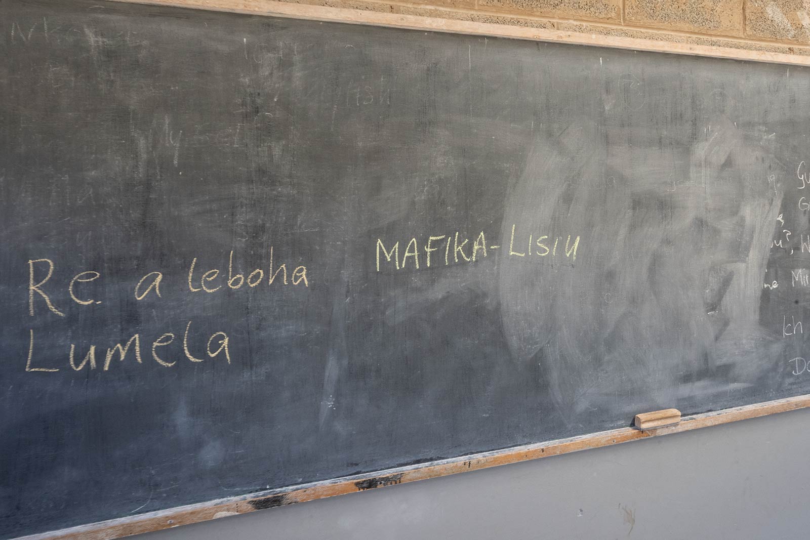 Blackboard with Swahili written on it in Lesotho, Africa. Getting drunk with the Maasai tribe in the Drakensberg