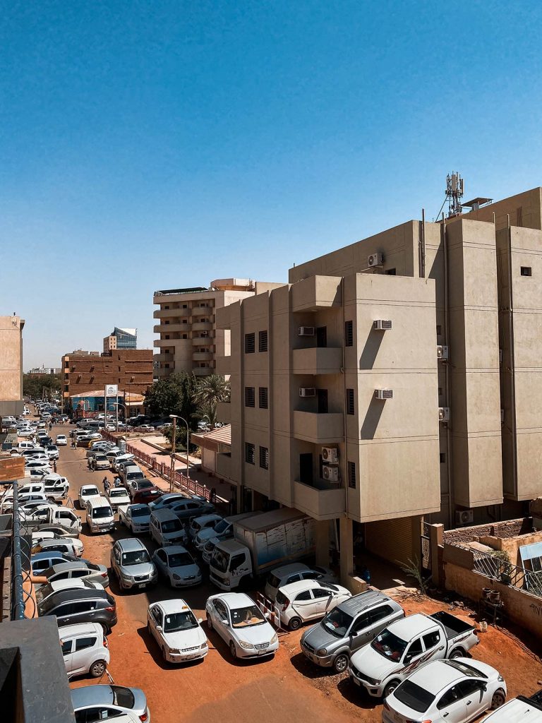 Parked cars near buildings in Sudan. Getting caught up in a protest in Sudan