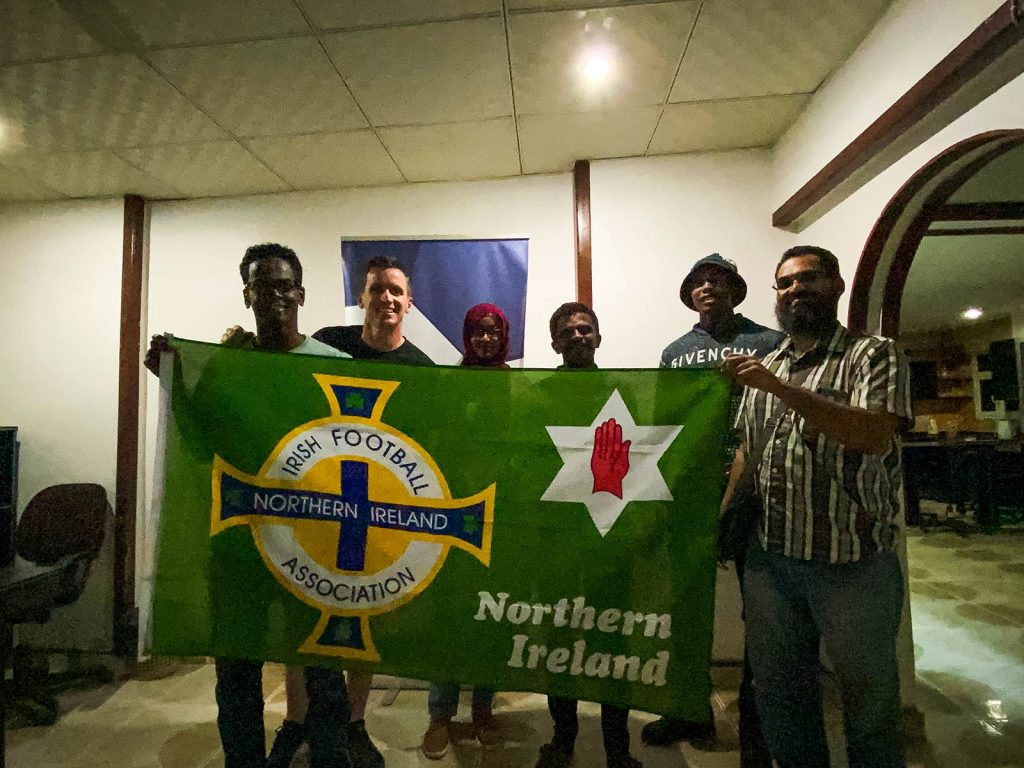 David Simpson and locals holding NI flag in Sudan. The best fish & learning English