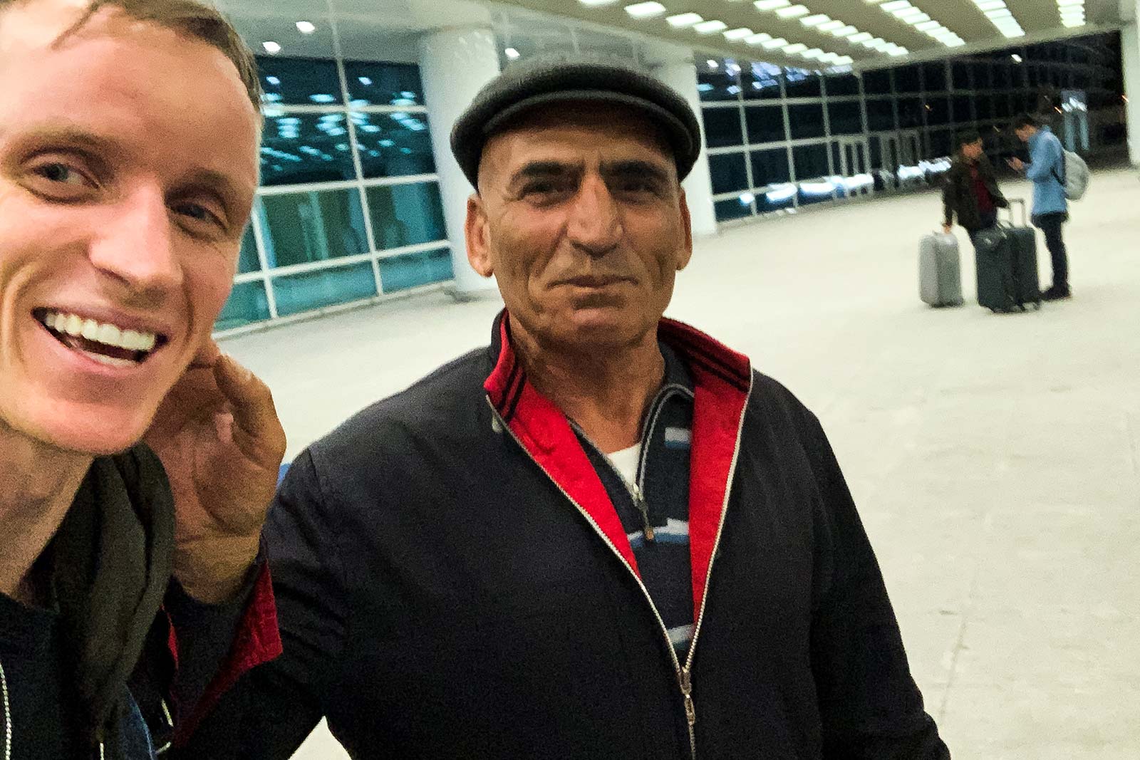 David Simpson and taxi driver at the airport in Ashgabat, Turkmenistan. Confused taxis and pick ups