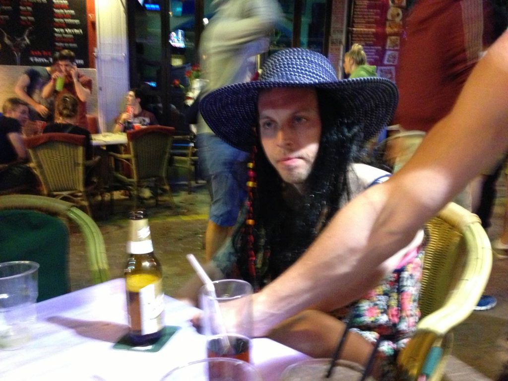 Man wearing hat drinking in Dalt Vila, Ibiza. Greatest party venue in the world