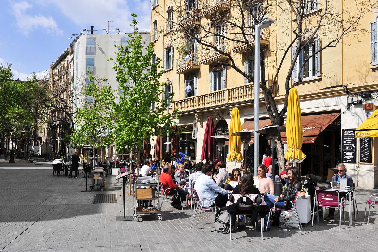 People sitting at sidewalk cafes in Passeig del Born in Barcelona. 10 things you must do in Barcelona