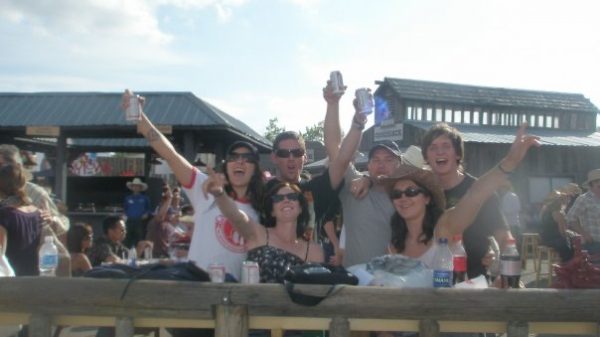 David Simpson with two guys and three girls raising their beer in Calgary. Calgary stampede