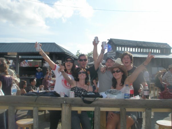 David Simpson with two guys and three girls raising their beer in Calgary. Calgary stampede