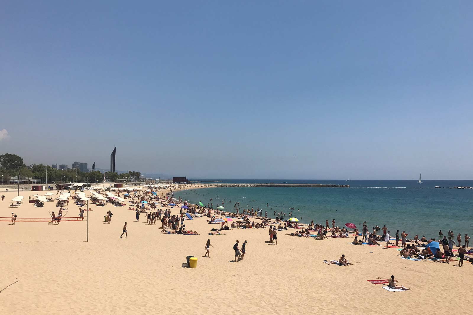 People enjoying the beach at La Barceloneta in Barcelona. 10 things you must do in Barcelona