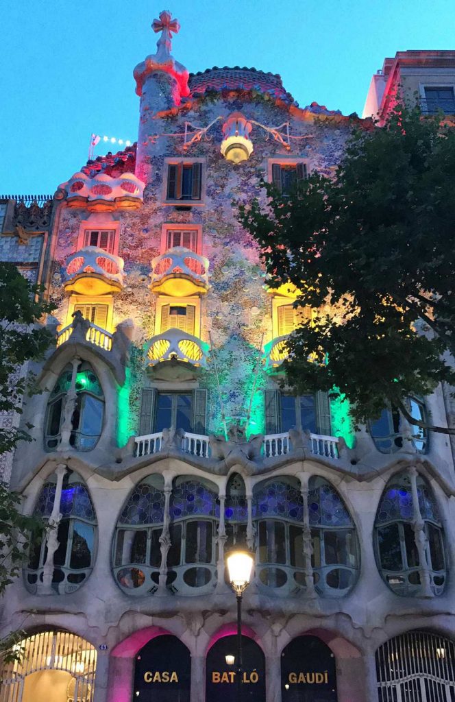 Casa Mila buildings lighted at sunset in Barcelona. 10 things you must do in Barcelona