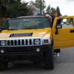 David Simpson beside the yellow humvee on the side of the road in Calgary. Cowboys in Calgary