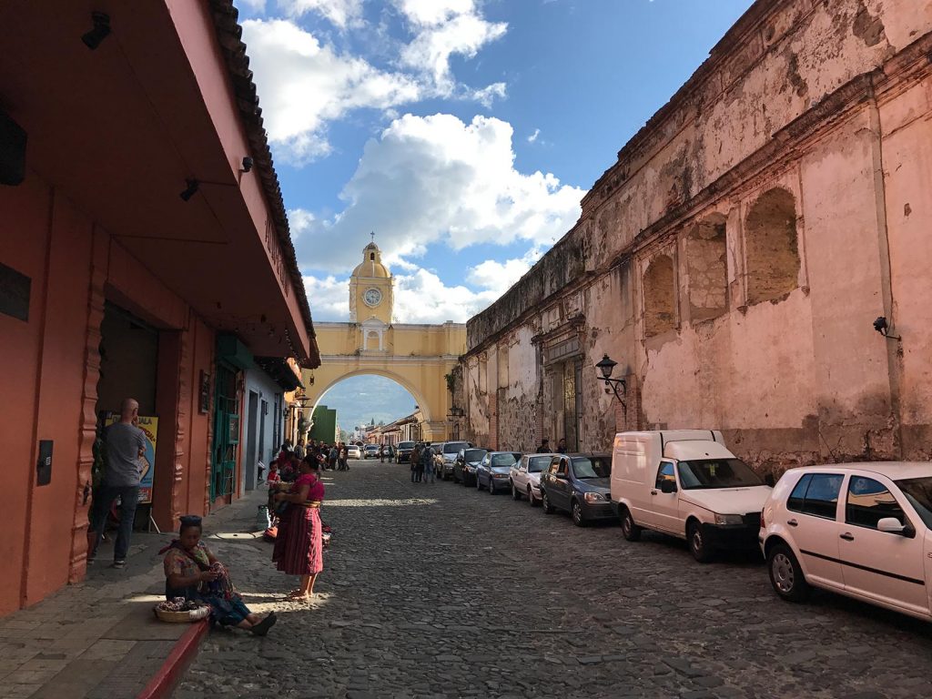 Cobblestone street lined with cars in Antigua, Guatemala. Volcanic diarrhea in Antigua