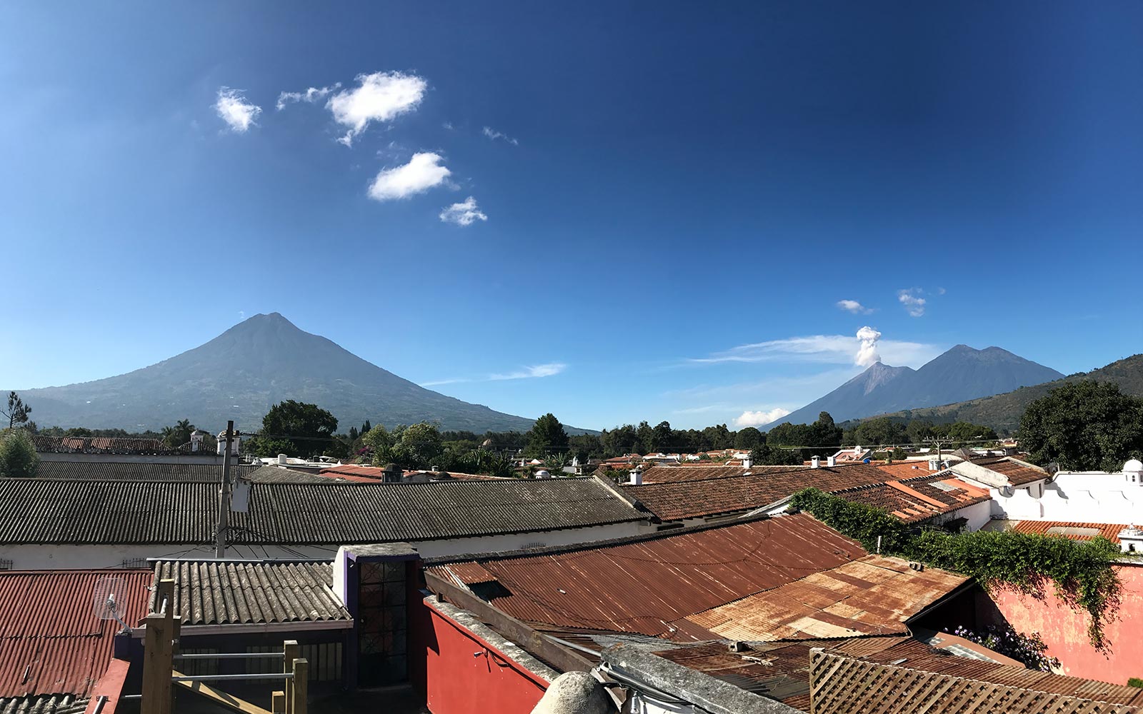 Rooftops and a volcano in Antigua, Guatemala. Volcanic diarrhea in Antigua