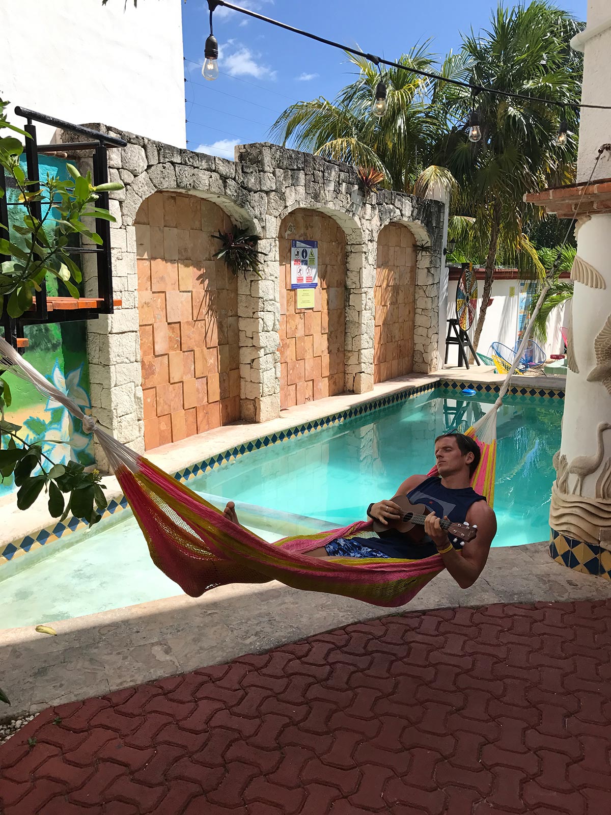 David Simpson on a hammock with ukulele by the pool in Cancun, Mexico. Chichén Itzá and the Yucatán coast