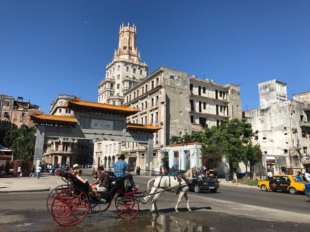 Horse drawn carriage and buildings in Havana, Cuba. Cigars, cars & cocktails in Cuba