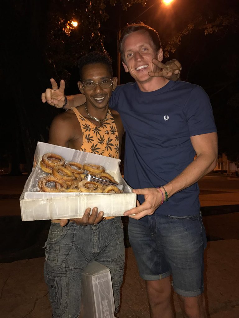 David Simpson with local selling donuts in Havana, Cuba. Cigars, cars & cocktails in Cuba